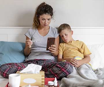 Mom using Symptom Checker on mobile phone to check on son's symptoms.