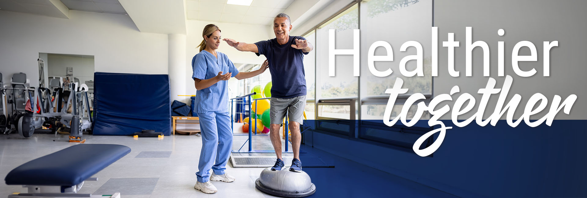 Mature man doing physical therapy exercises using a balance ball with the guidance of his therapist