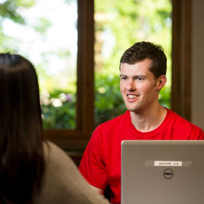 young man talking to a young woman