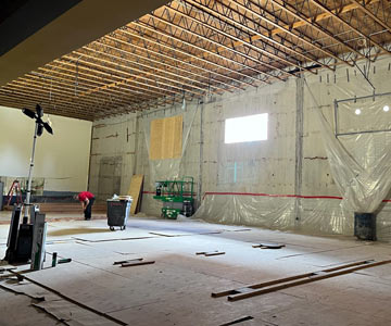 Sun shines through a new window of the partially completed interior of the Albany SamFit. It is being restored after a fire last year.