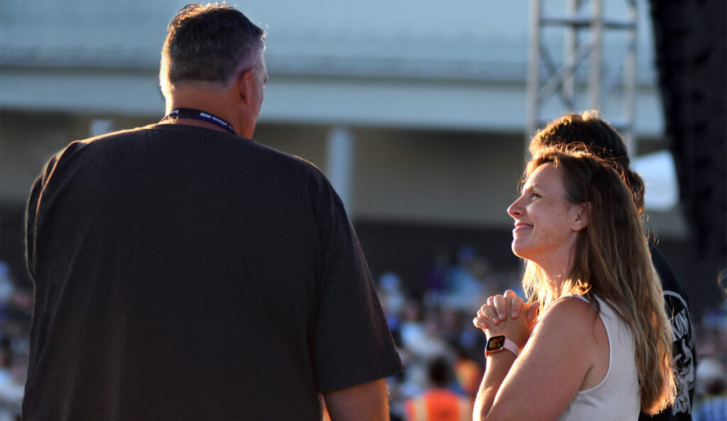 Angie looking up at Scott and smiling while on stage at the fair.