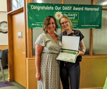 Jennifer Broadus (left), vice president of patient services, proudly awarded Conser (right) with the DAISY Award.