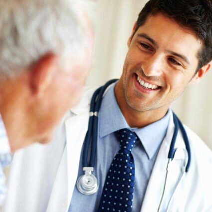 Male doctor talking to an elderly male patient.