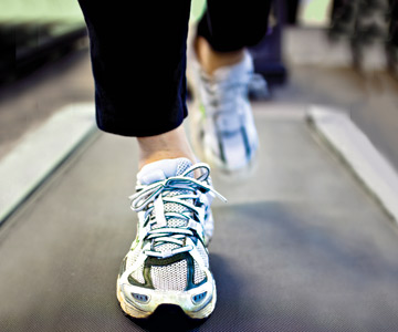 Sneakered feet on treadmill.