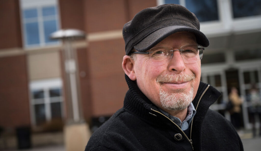 Randall smiling front of a building on the OSU campus.