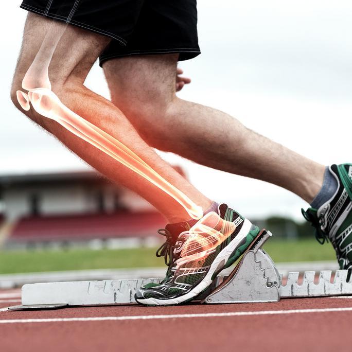 Digital composite of Highlighted knee of man about to race