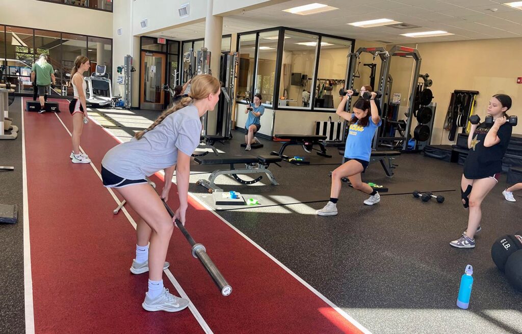 Girls doing weight training at Girl's Strength Camp held each summer at The SAM.