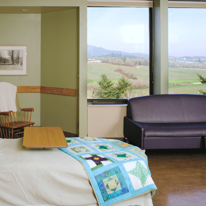 Birthing suite with a bed, window and couch. Center for Women & Families in Corvallis, Oregon.