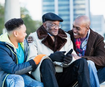 Family gathered together including a grandfather, parent and child.