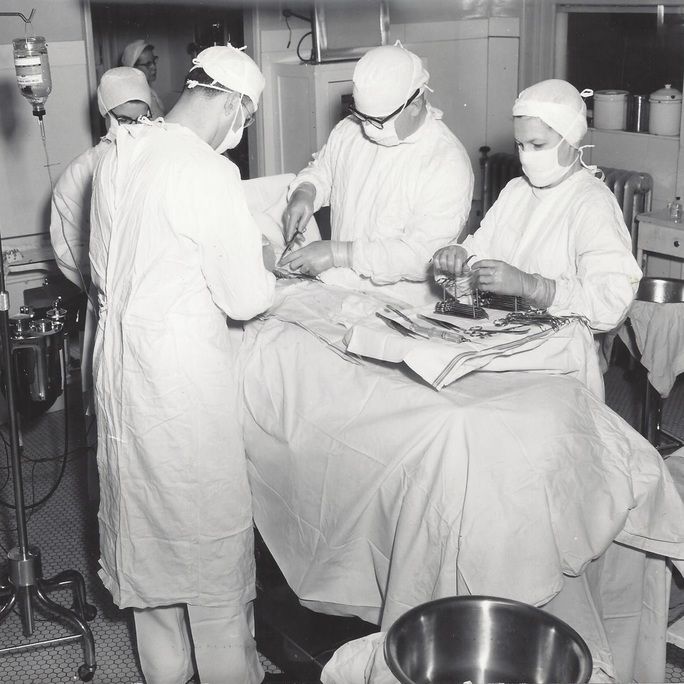 Historical scene of surgeons performing surgery in operating room