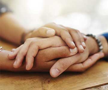 Hands held in support