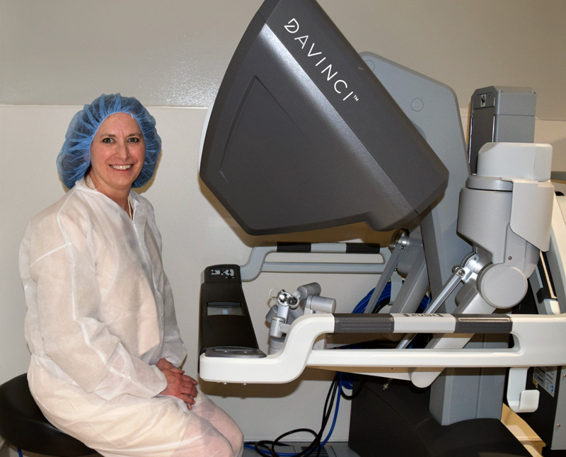 Karla sitting at the da Vinci robot console.