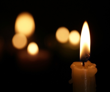 A close up of a single candle.
