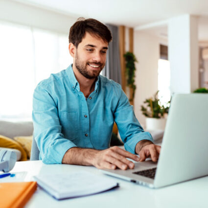 Man sitting in front of his laptop typing.