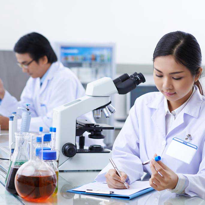 Lab technicians doing paperwork.