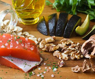Salmon, avocado, olive oil, nuts on board - mediterranean diet