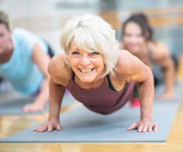 Older woman doing a plank exercise.