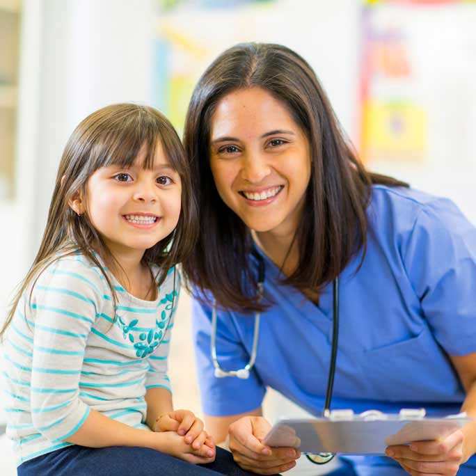 nurse and little girl smiling