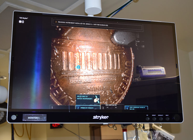 Monitor view of a close up of a penny, demonstrating the magnification capabilities of the da Vinci robotic system.