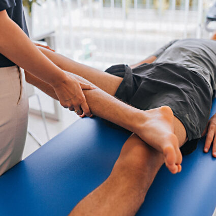 Physical therapist working with patient who has a knee injury.