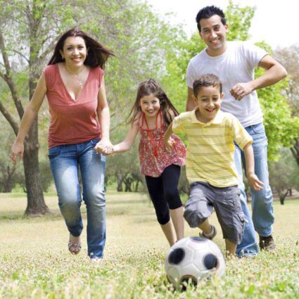 family playing soccer - well-child checks promote good health