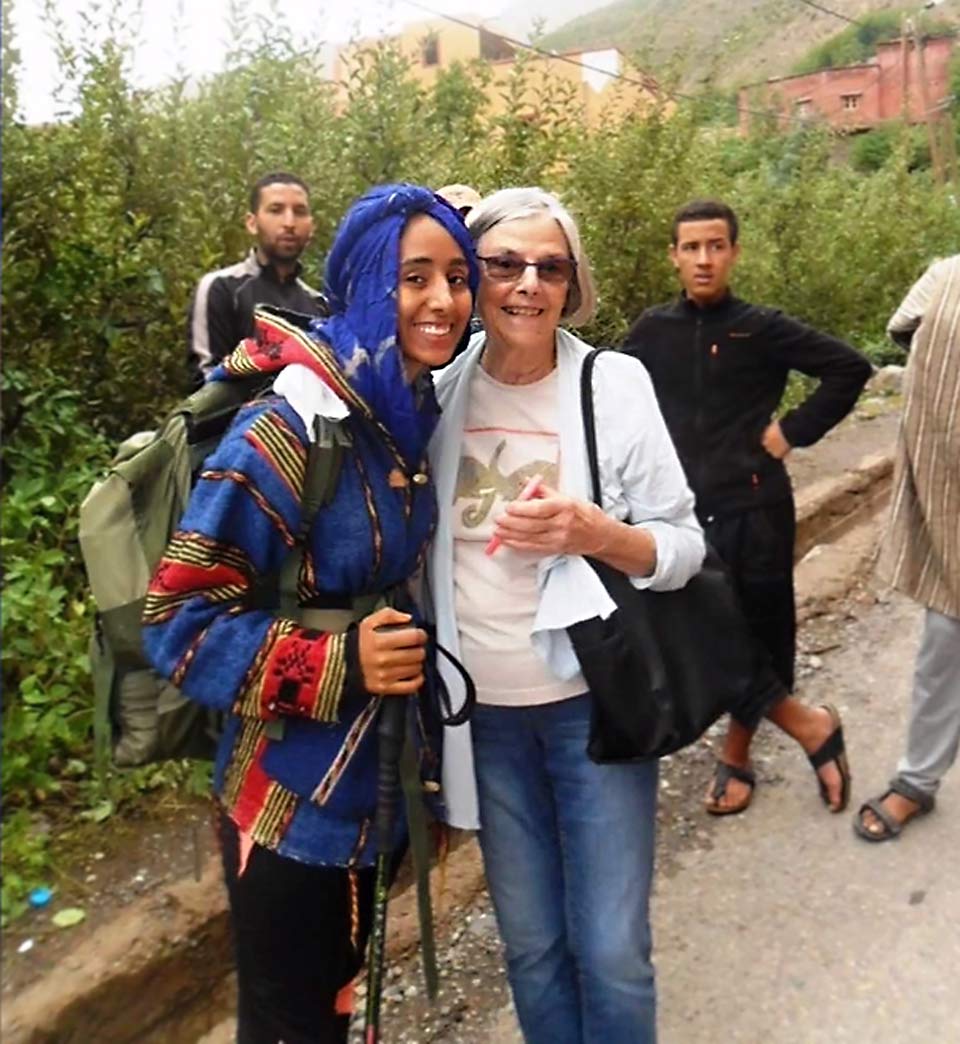 Alice on a hike stopping to smile with one of the students she worked with while volunteering in Morocco.
