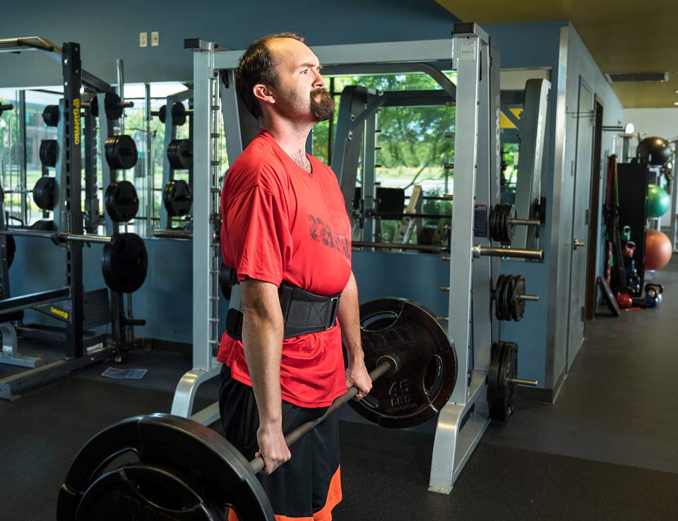 Anthony lifting weights at SamFit.
