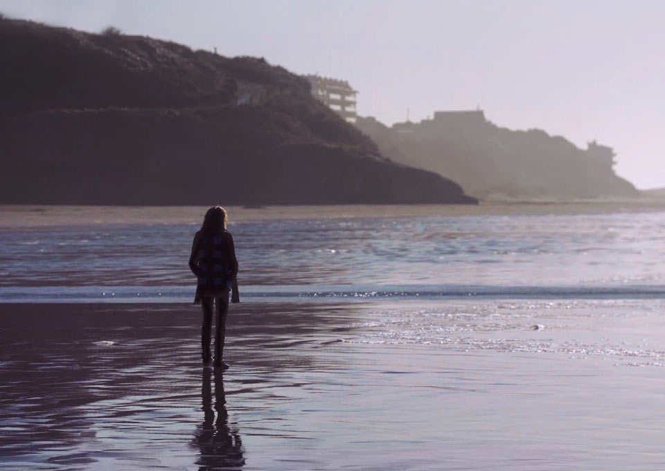 A silhouette of Cyndee as she walks along the beach in Newport, Oregon.