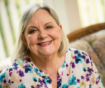 Close up of a smiling Donni looking directly at the camera.
