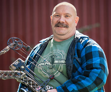 Jon McKibben holds his bow.