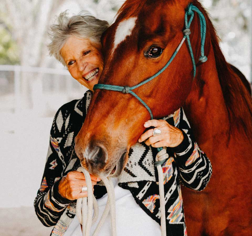 Kathy laughs as she and her horse stop for a close up photo.