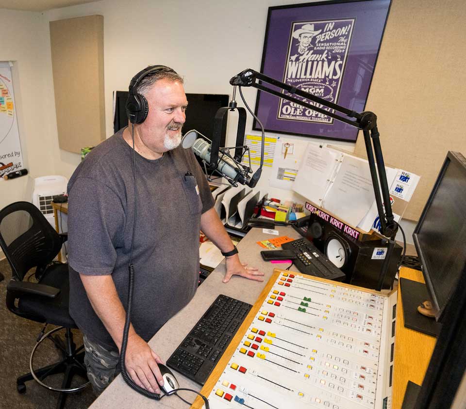 Scott at work in front of his microphone at the radio station.
