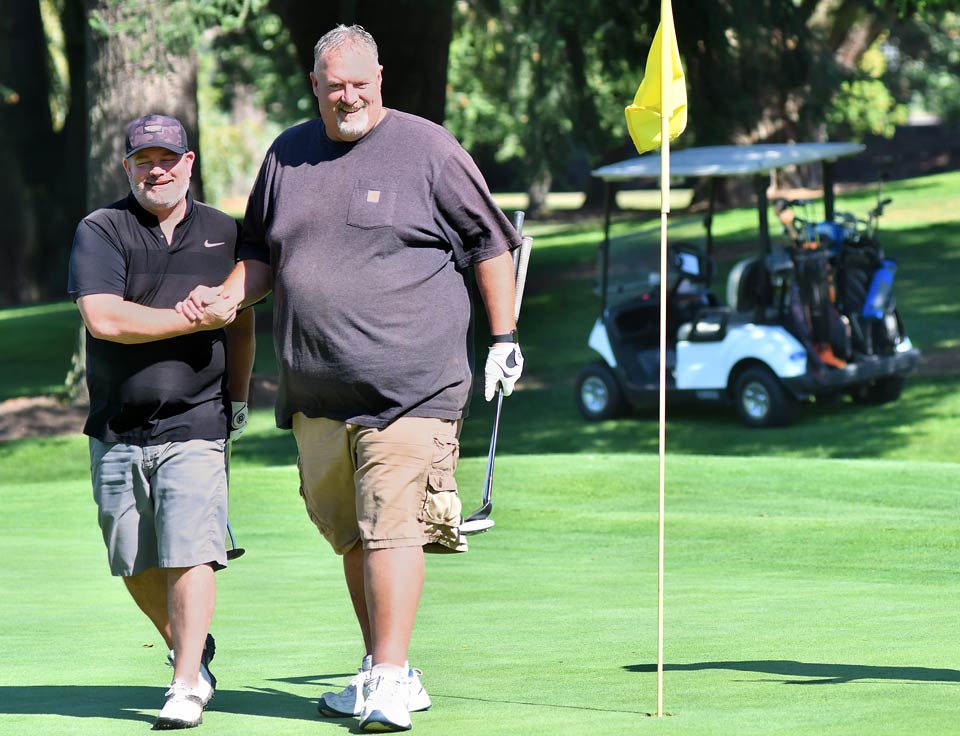Scott and a close friend playing golf.
