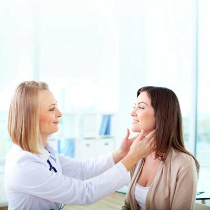 Resident checks a patient's lymph nodes in neck.