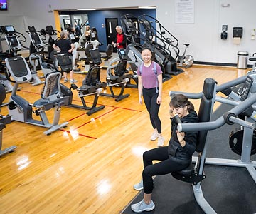 Visitors check out the SamFit-Albany with fresh paint and new equipment during the Grand Reopening event in May 2024.