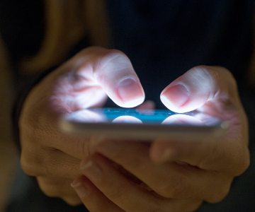 Hands holding cell phone