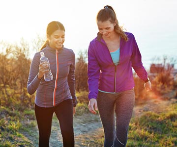 Women hiking with water bottles