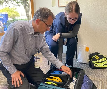 Dr. Cosimo Storniolo and a nurse from the Samaritan InterCommunity Health Clinci's Street Medicine team preparing equipement to serve the community.