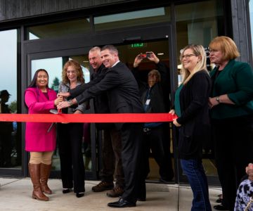 A group of Samaritan employees and city officials cutting the ribbon at the Sweet Home Medical Center open house.