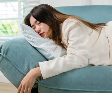 Tired woman sleeping on the couch.