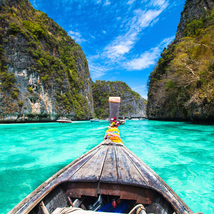 Tropical setting for small wooden boat on water