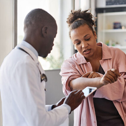 Woman being seen by a dermatologist.