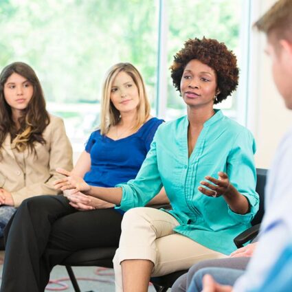 Woman talking in a group.