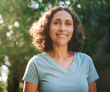 Woman smiling outdoors.