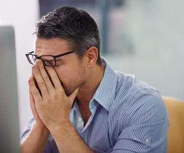 Man holding his face